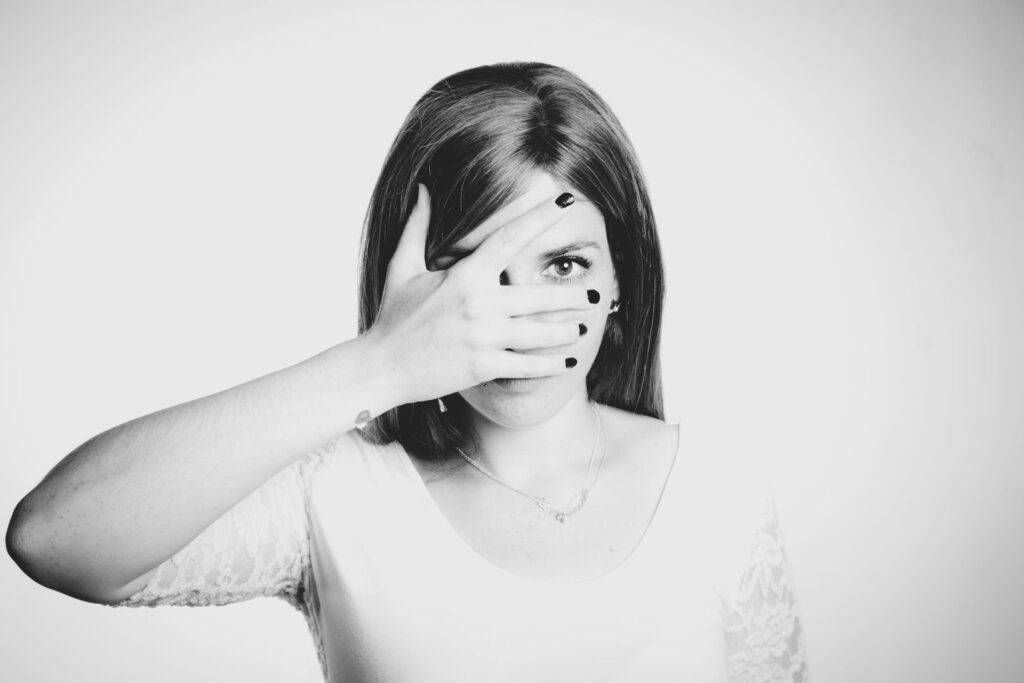 Woman with a hand over her face