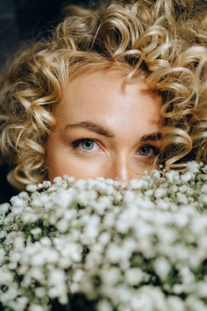Woman looking over some flowers