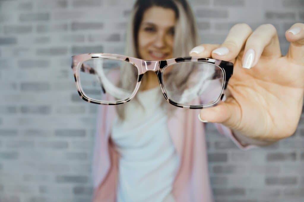 Woman holding eyeglasses